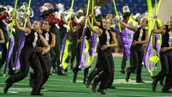 2001 Santa Clara Vanguard color guard - wearing wrist watches, uniforms with hands of a clock, and with flags depicting clock faces