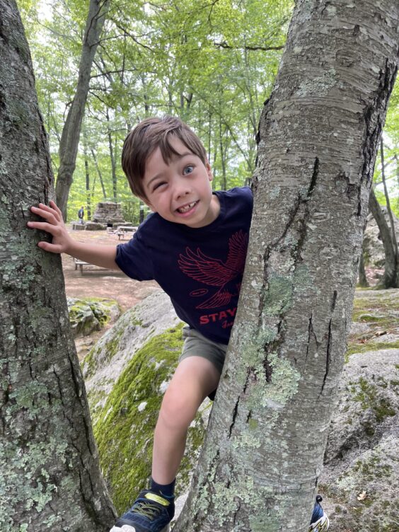 Myron winking and peering through tree branches
